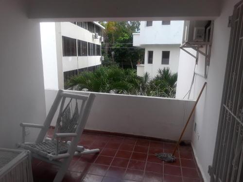 a balcony with a chair and a mop at Dre Broeders Apartments Juan Dolio in Juan Dolio