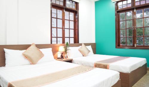 Postel nebo postele na pokoji v ubytování Hưng Long Hostel