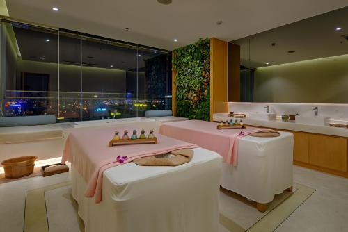 a bathroom with two tables and a sink at TMS Hotel Da Nang Beach in Da Nang