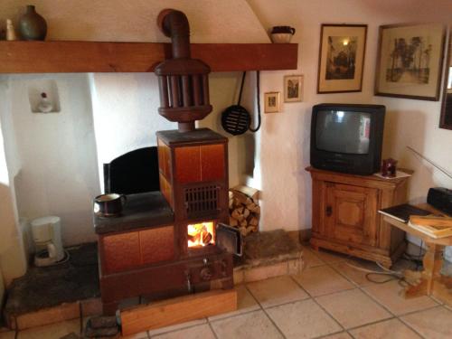 a fireplace in a living room with a tv at Girasole Orselina in Orselina