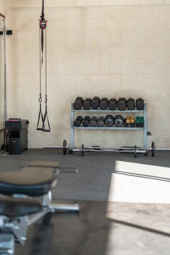 a gym with a row of weights on a wall at Casa Prana Hotel in Atitlan in Santa Cruz La Laguna