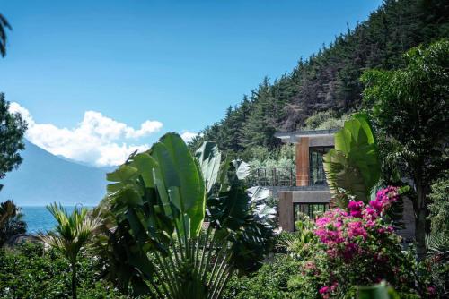 a house on the side of a hill with plants at Casa Prana Hotel in Atitlan in Santa Cruz La Laguna
