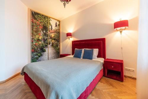 a bedroom with a bed and a painting on the wall at Old Town - Viru Gate Apartment in Tallinn