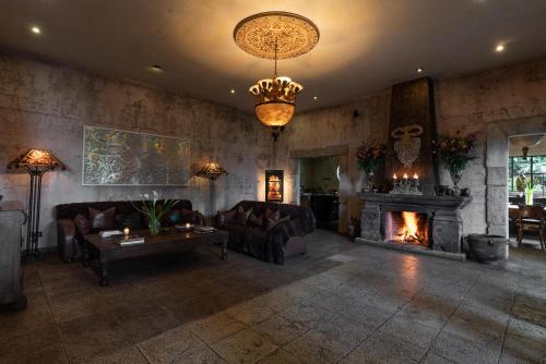 a living room with couches and a fireplace at Casa Prana Hotel in Atitlan in Santa Cruz La Laguna