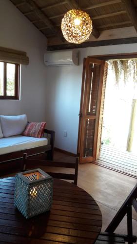a living room with a couch and a table at Dharma in Punta Del Diablo