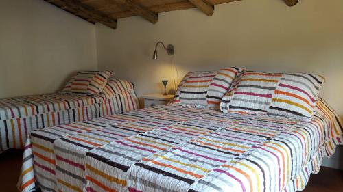 a bedroom with a bed with a striped comforter at Dharma in Punta Del Diablo