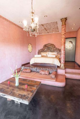 a bedroom with a large bed and a table at Casa Prana Hotel in Atitlan in Santa Cruz La Laguna
