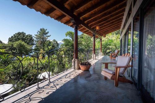 a balcony with a table and chairs on a house at Casa Prana Hotel in Atitlan in Santa Cruz La Laguna