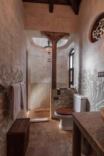 a large bathroom with a toilet and a shower at Casa Prana Hotel in Atitlan in Santa Cruz La Laguna