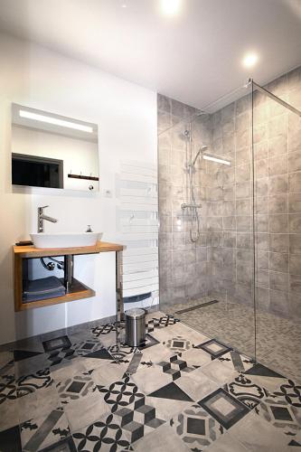 une salle de bain avec un lavabo et une douche dans l'établissement La Forge, à Montséret