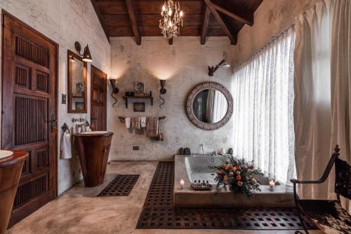 a large bathroom with a tub and a mirror at Casa Prana Hotel in Atitlan in Santa Cruz La Laguna