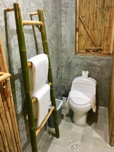 a bathroom with a toilet and a toilet paper at Kalulushi Bungalows in Haad Pleayleam