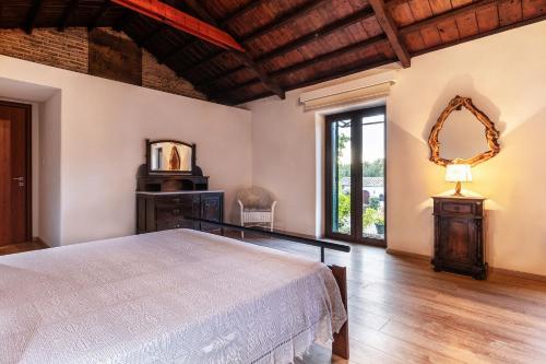 a bedroom with a bed and a mirror at Flabouriaris Estate in Anafonítria