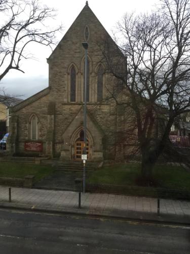 a church on the side of a street at Abbey Court Guest House in Carlisle