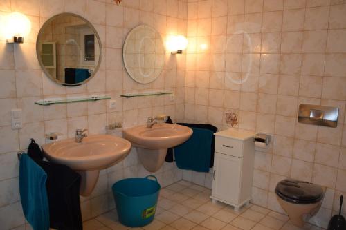 a bathroom with two sinks and a mirror at FEWO-Horgau in Horgau