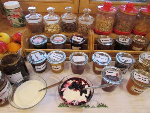 a table with a bowl of food and jars of preserves at Grillinghof in Kirchberg in Tirol
