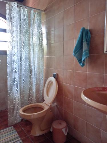 a bathroom with a toilet and a sink at Casa de veraneio Lar doce mar in Capão da Canoa