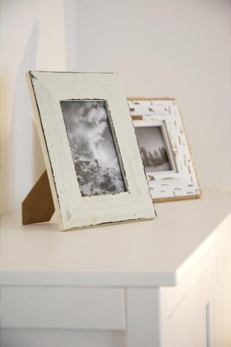 two framed photographs sitting on a white table at Mountainlodge by Skischule Hermann Maier in Flachau