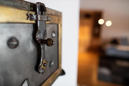 a close up of a metal door with a latch at Meisser Lodge in Guarda