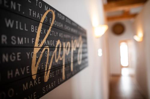 a black and gold sign hanging on a wall at Meisser Lodge in Guarda