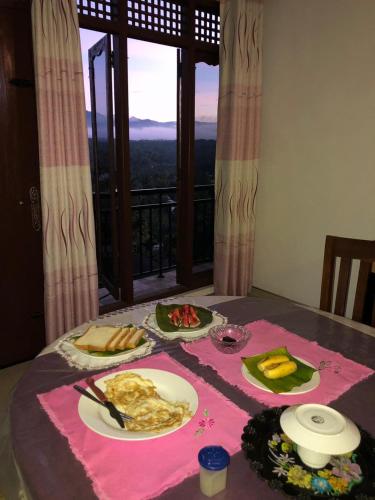 a table with plates of food on it with a view at Dreamscape home stay in Kandy