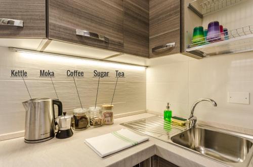 a kitchen with a sink and a counter top at S.Felice Apartments in Bologna