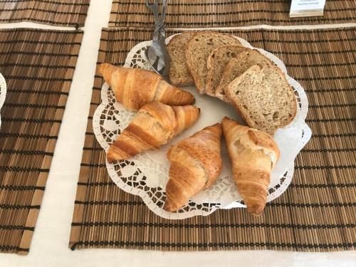 a plate of bread and croissants on a table at Quinta de São José dos Montes in Ferreira do Zêzere