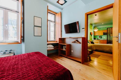 a bedroom with a red bed and a mirror at Lisbon Art Stay Apartments Baixa in Lisbon