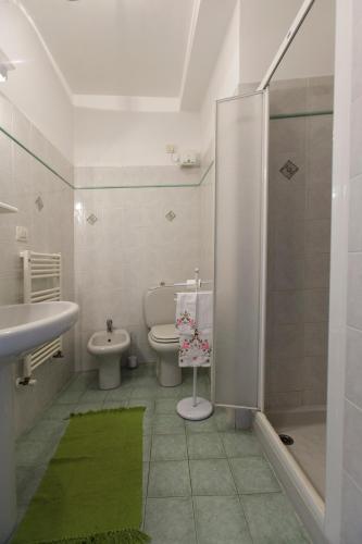 a bathroom with a toilet and a sink and a shower at Casa Lella in Portovenere