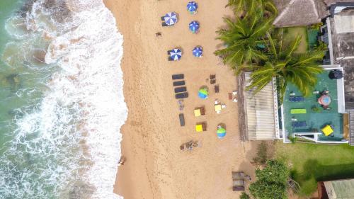 an overhead view of a beach with chairs and umbrellas at Hotel Apollo in Hikkaduwa