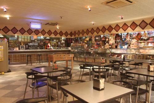 a restaurant with tables and chairs and a bar at Hostal Santa Ana in Madridejos