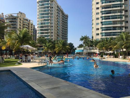 a group of people in a swimming pool with buildings at Apartamento Bora Bora in Rio de Janeiro