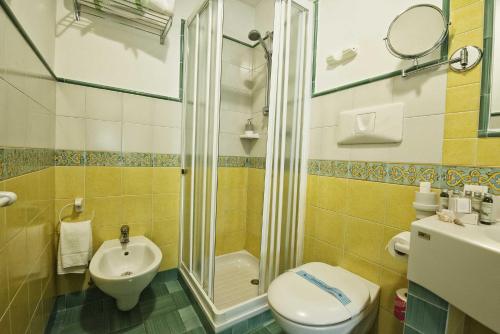 a bathroom with a shower and a toilet and a sink at Grand Hotel Il Ninfeo in Gaeta