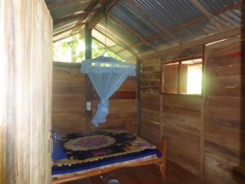 a small room with a bed in a wooden cabin at Angry Birds Tree house in Habarana