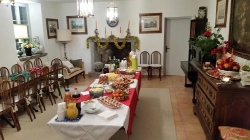 a dining room with a table with food on it at Hotel Soazza in Soazza