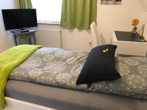 a bedroom with a bed with a pillow on it at Messezimmer 4u in Düsseldorf