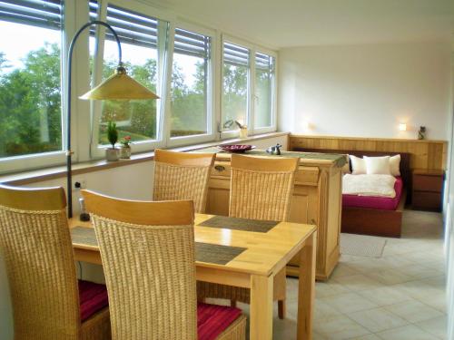 a dining room with a table and chairs and a bed at PenthouseApartment 250° in Sonthofen