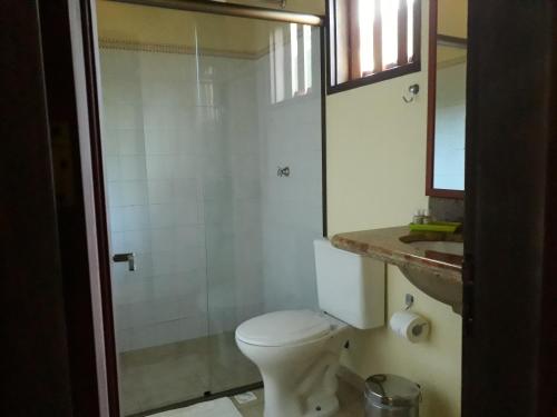 a bathroom with a shower and a toilet and a sink at Pousada da Terra Paraty in Paraty
