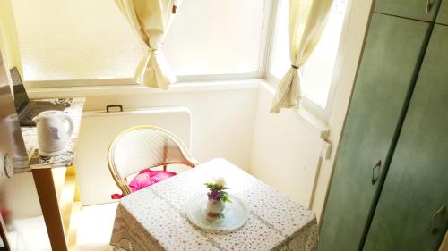 a small table with a vase on it in a room at Lovely Little Apartment near Beach in Netanya