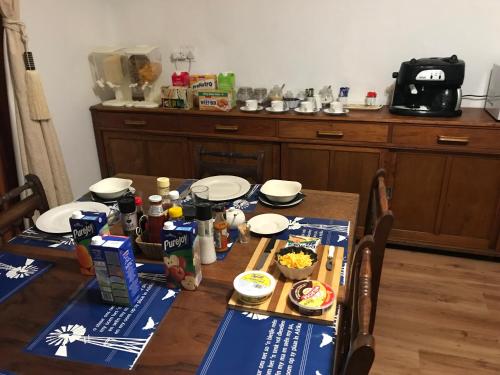 a table with plates and food on top of it at Towerzicht Guest House in Ladismith