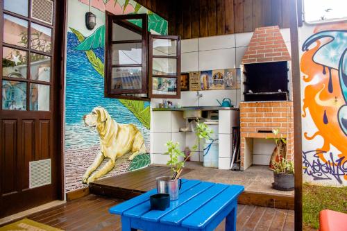 a living room with a mural of a dog on the wall at Floripa Surf Hostel in Florianópolis
