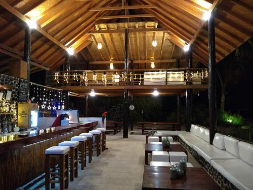 a bar with a bunch of chairs and tables at Hotel Villa Sirena in Vichayito
