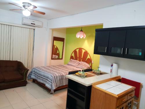 a small bedroom with a bed and a kitchen at Contry La Silla Apartments zona tec - Nuevo Sur in Monterrey