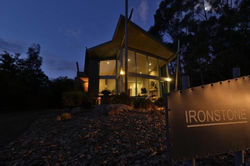 a home at night with a sign in front of it at Ironstone Romantic Couples Retreat in Halls Gap