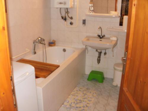a bathroom with a tub and a sink and a toilet at Vass Vendégház in Eger