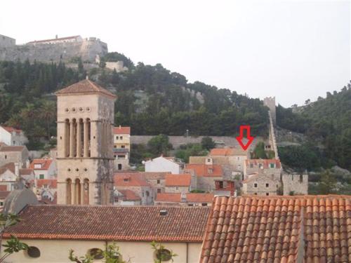 a view of a city with a red arrow at Apartments Seka in Hvar