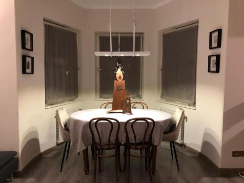 a dining room with a table and some windows at Cavalese Mountain Luxury Apartment in Cavalese