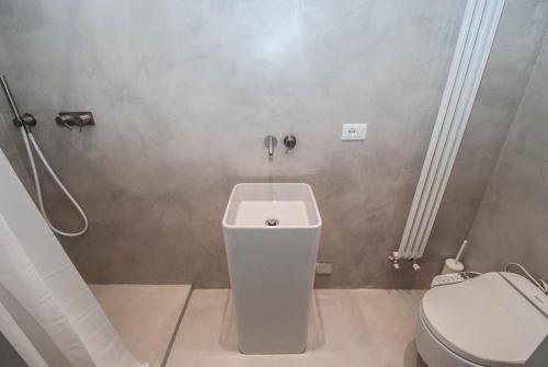 a bathroom with a white toilet and a shower at Luxury Apartments Manarola by Arbaspàa in Manarola