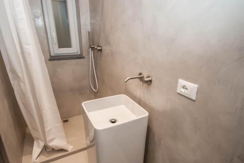 a bathroom with a white toilet and a shower at Luxury Apartments Manarola by Arbaspàa in Manarola