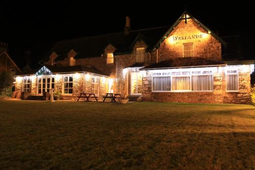 a building with lights on it at night at Westlands of Pitlochry in Pitlochry